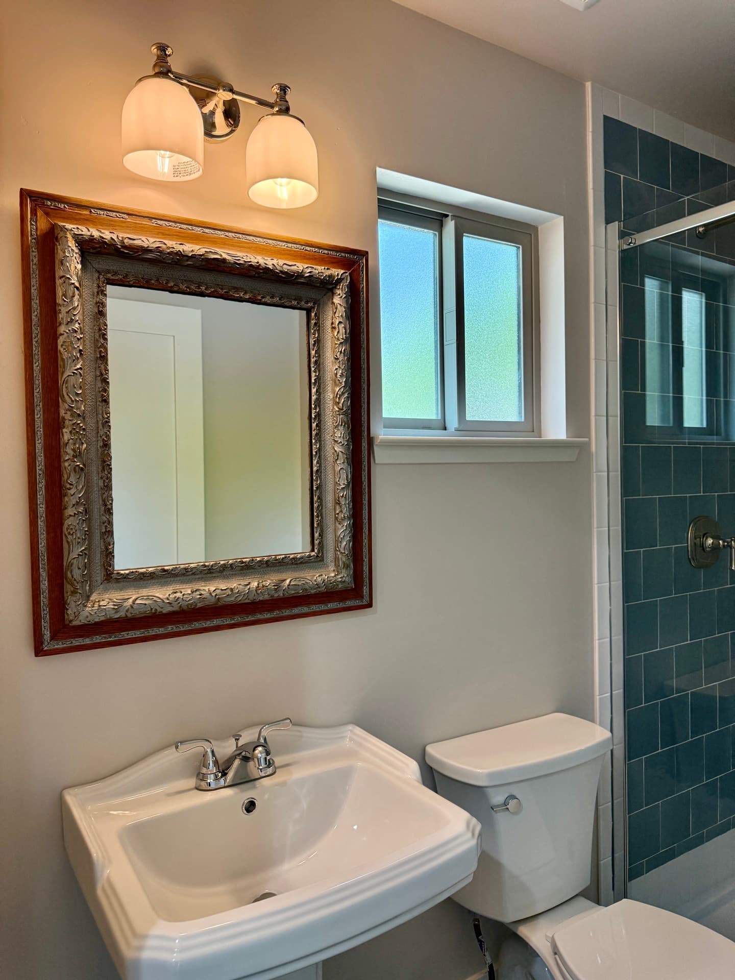 Roseville detached ADU — bathroom with vintage mirror and tiled shower — gallery thumbnail 8