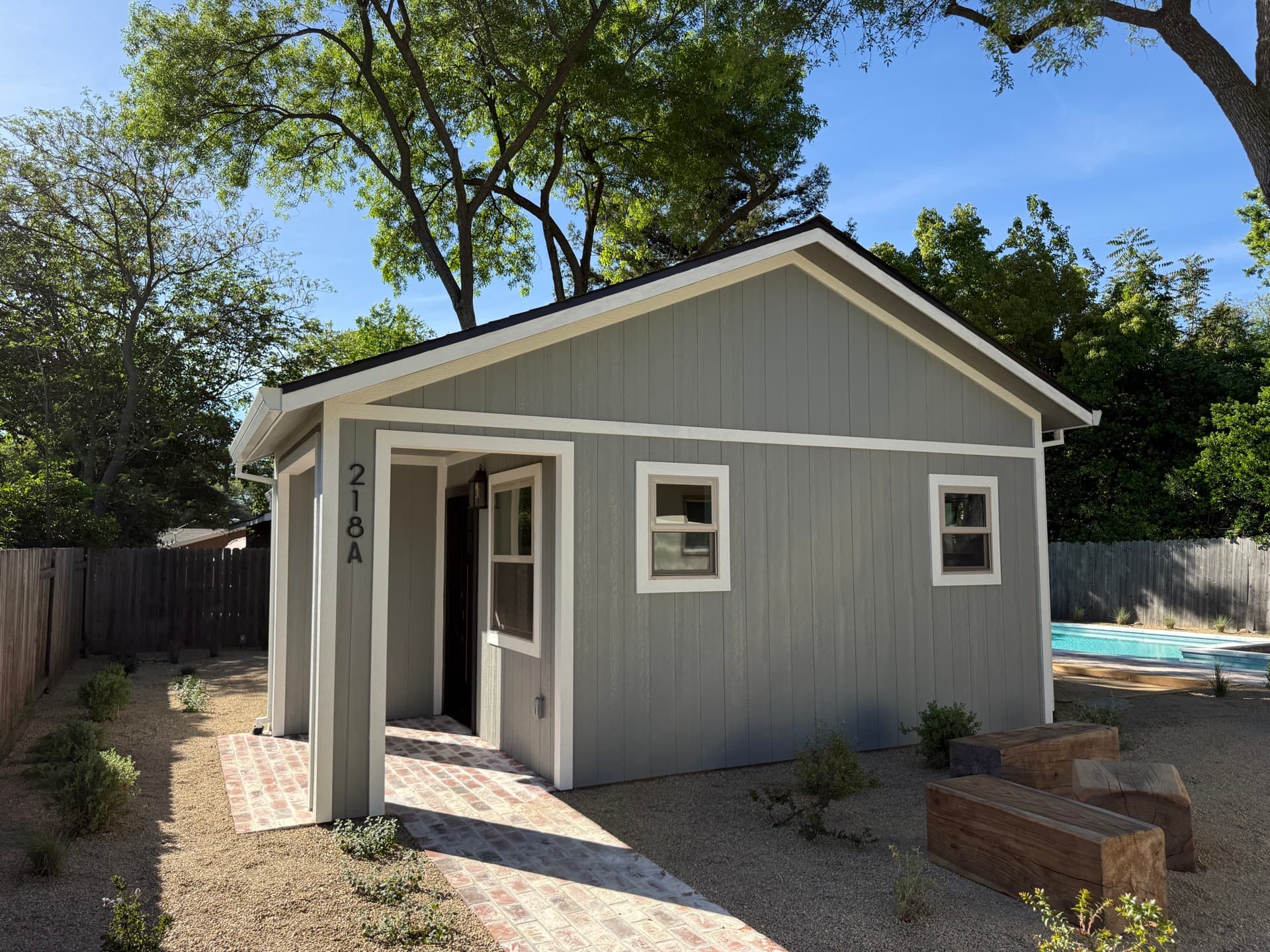 Two-story detached Roseville ADU with cream lap siding, gabled roof and address 218A above the front door