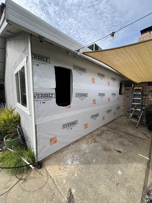 Side view of the site preparation for the new siding to be installed home remodeling project